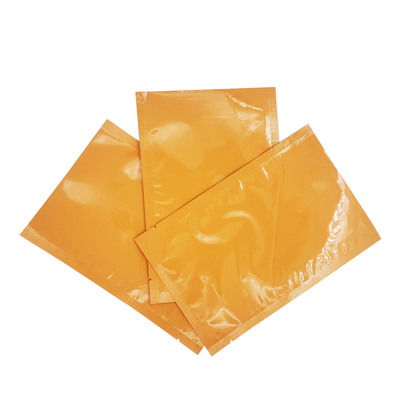 kupować Folia aluminiowa laminowana błyszcząca koloru pomarańczowego niestandardowe płaskie torebki do maski twarzy, opakowania kremów do twarzy online manufacture